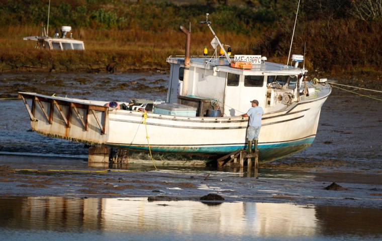 Image: A lobsterman inspects his fishing boat