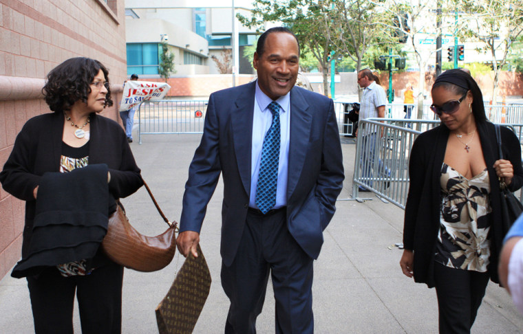 Image: O.J. Simpson arrives with his sister Carmelita Durio and his daughter Arnelle