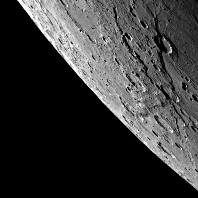 The features this image from MESSENGER's Oct. 6, 2008 flyby shows never-before seen terrain. The region in the foreground near the right side of the imag is close to the border between darkness and daylight, so shadows are long and prominent. Two very long scarps are visible in this region, and the scarps appear to crosscut each other. The easternmost scarp also cuts through a crater, showing that it formed after the impact that created the crater. Other neighboring impact craters, such as in the upper left of this image, appear to be filled with smooth plains material. Credit: NASA/JHUAPL/CIW.