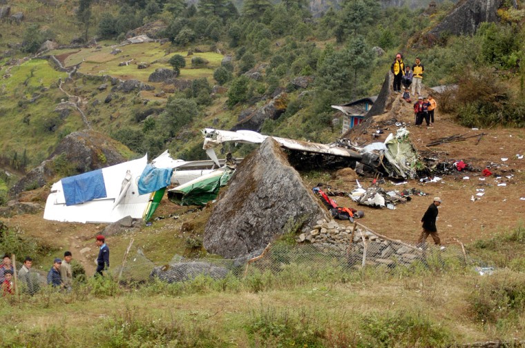 Image: The crash site of a Twin Otter aircraft is seen near the runway at Lukla airport in east Nepal