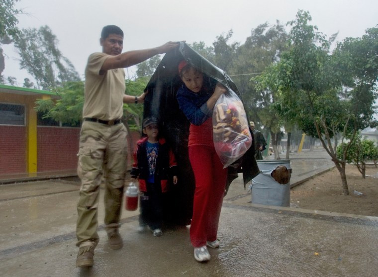 Image: Mexican Soldier Gustavo Rodriguez helps Laura Alvarado