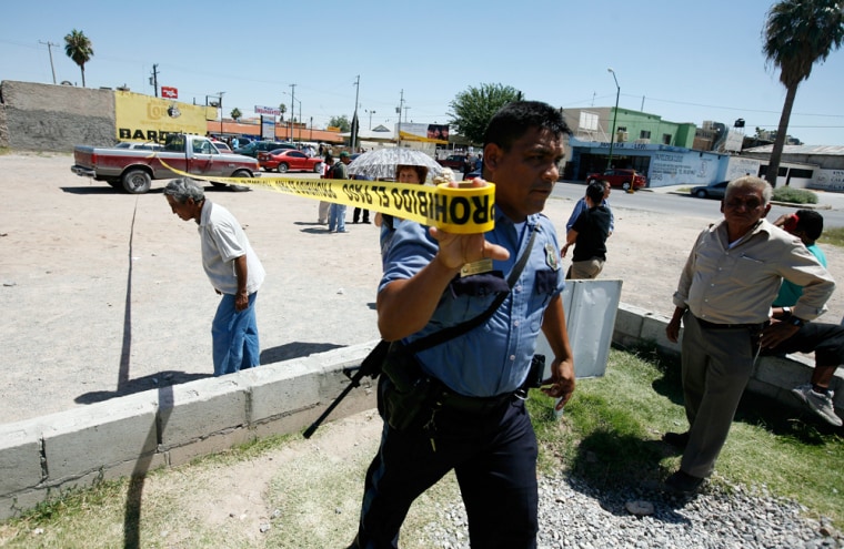 Image: A police officer cordons off a crime scene