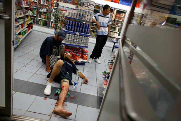Image: A man takes refuge inside a store