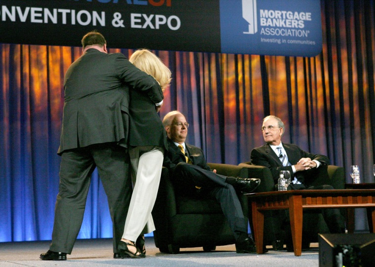 Image: A demonstrator is pulled off the stage after she approached Karl Rove
