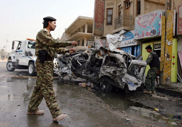 Image: Damaged car after a suicide car bomber struck in central Baghdad