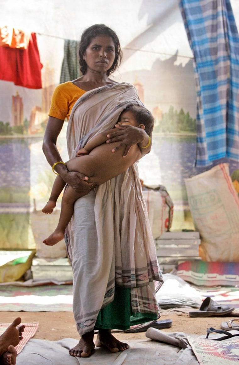 A Christian victim of violence from Hindu hard-liners holds a child at a relief camp in Bhubaneshwar, India, Monday, Oct. 13, 2008. (AP Photo/Gurinder Osan) **