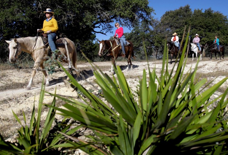 Visitors take a morning ride at the Dixie Dude Ranch near Bandera, Texas, Friday, Oct. 24, 2008.  (AP Photo/Eric Gay)