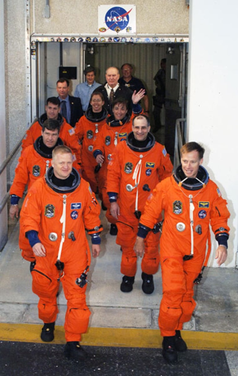 The STS-126 crew members eagerly exit the Operations and Checkout Building at NASA's Kennedy Space Center in Florida to practice launch day activities for their Nov. 14, 2008 blast off. 