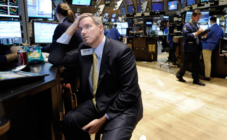 Image: Specialist Gregg Reilly works at his post on the New York Stock Exchange floor