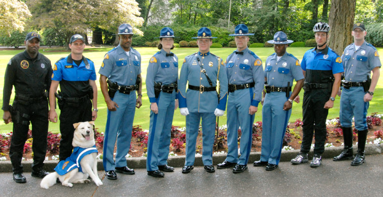 Washington State Patrol troopers display a variety of their uniforms, including SWAT, K-9, sergeant, winter (also known as dress, with a long sleeve and bow tie), honor guard, summer (short sleeve), bicycle and motorcycle.