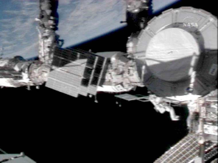 This video grab provided by NASA shows space shuttle Discovery Mission Specialist Scott Parazynski working Sunday on the outside of the international space station's newly installed Harmony nod during the second of five planned spacewalks.