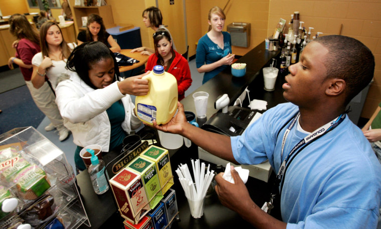 Image: Kwesi Utley, right, serves customers in the library coffeehouse at Centennial High School in Franklin, Tenn.