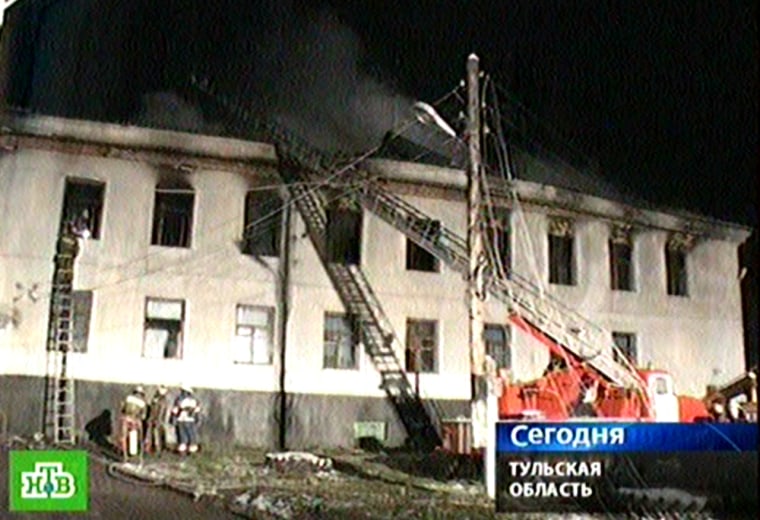 Image: Firefighters extinguish a fire at a nursing home in Velye-Nikolskoy