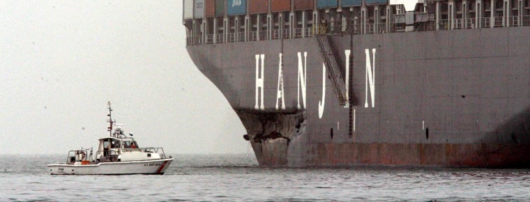A Hanjin container ship that struck the Bay Bridge tower sits idle off of Treasure Island as a U.S. Coast Guard vessel inspects the damage on the freighter in San Francisco, Wednesday, Nov. 7, 2007. The Coast Guard says there's no damage to the Bay Bridge after the ship bumped a tower supporting the bridge. The incident happened in the morning during a heavy fog. (AP Photo/San Francisco Chronicle, Michael Macor) ** MANDATORY CREDIT FOR PHOTOG AND SAN FRANCISCO CHRONICLE; NO SALES; MAGS OUT **