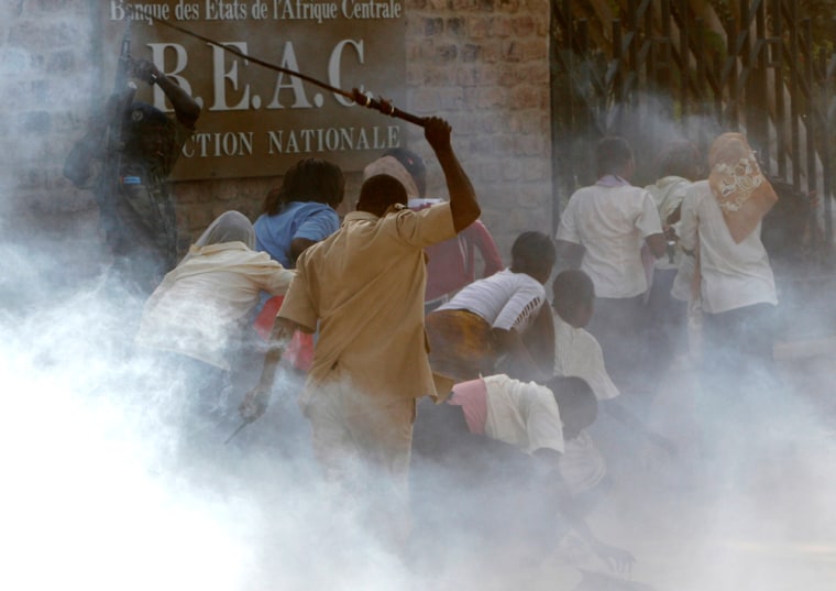 Riot police disperse secondary school students taking part in an anti-French demonstration in the capital N'Djamena