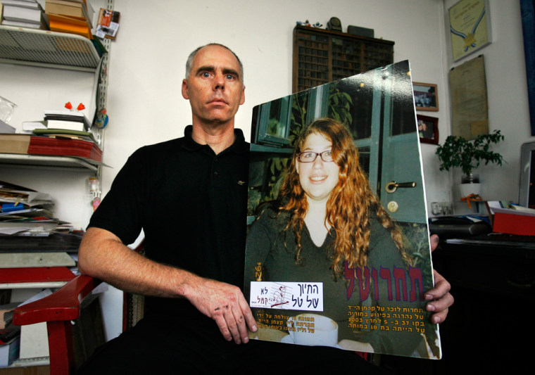 Image: Ron Kehrmann holds  a picture of his  daughter Tal, who was killed by a Palestinian suicide bombe.