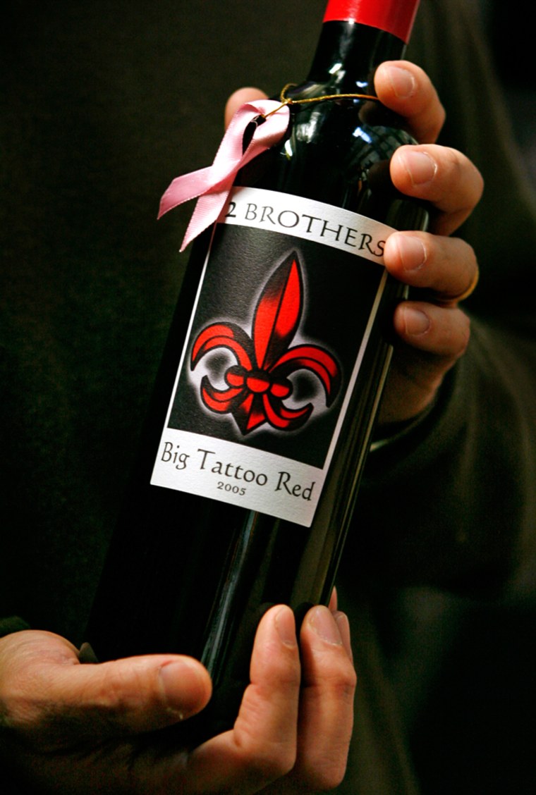 Alex P. Bartholomaus, President and CEO of Billington Wines, holds a bottle of Big Tattoo Red, the wine label his family started in honor of his mother who died of breast cancer, at his business in Springfield, Va. on Friday, Nov. 16, 2007.  (AP Photo/Jacquelyn Martin)