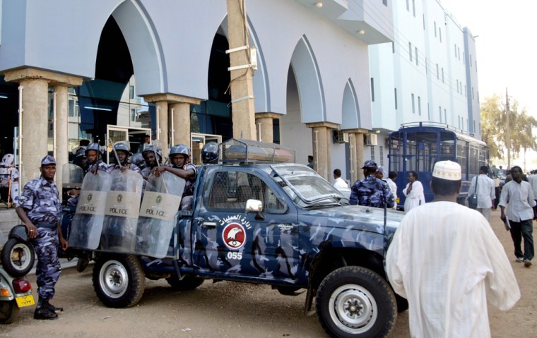 Sudanese anti-riot policemen stand alert outside the Khartoum court on Thursday.