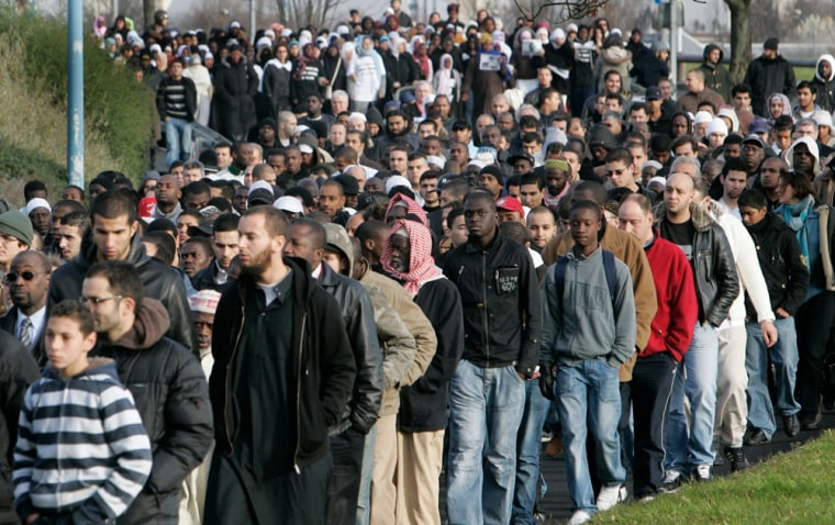 Image: Residents march during a ceremony for teenager Lakamy Samoura