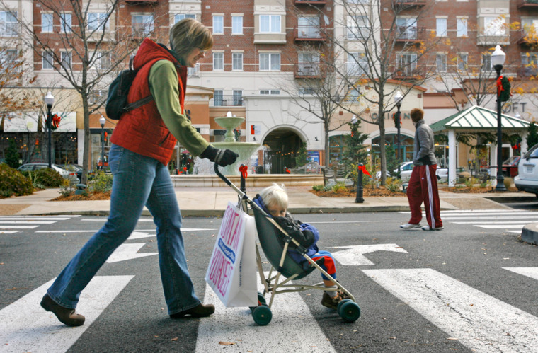 Kristine Bruce, of Arlington, Va., left, walks her son David Bruce, 2, through the Arlington neighborhood of Clarendon, Monday, Dec. 3, 2007.