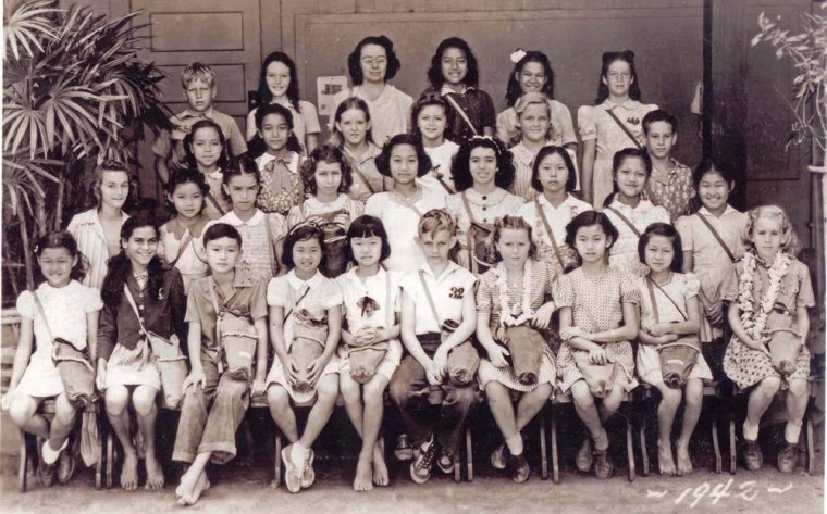 Image: students in Mrs. Carvalho's fifth grade class at Thomas Jefferson Elementary in Waikiki sit clutching their gas masks.