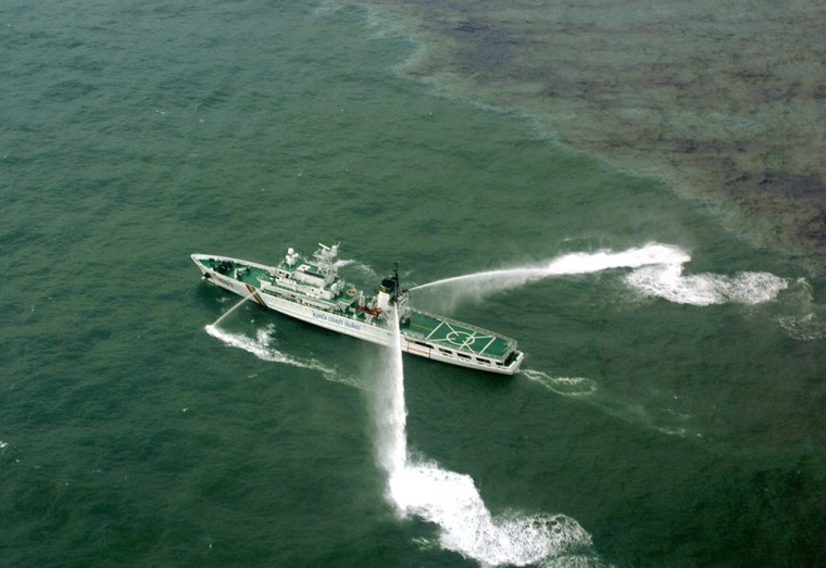 A South Korea's Coast Guard ship spays dissolving agent over oil-covered water to prevent furhter spread of the oil spilt by a Hong Kong-registered tanker after an accident near the Mallipo beach, South Korea, Friday, Dec. 7, 2007. The spill released about 66,000 barrels (10.5 million liters; 2.7 million gallons), said Coast Guard officer Jung Se-hi. Earlier, ministry officials had cited a larger figure of about 110,000 barrels for the spill.