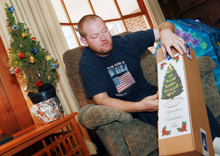 Image: James Ward holds a packaged Christmas tree
