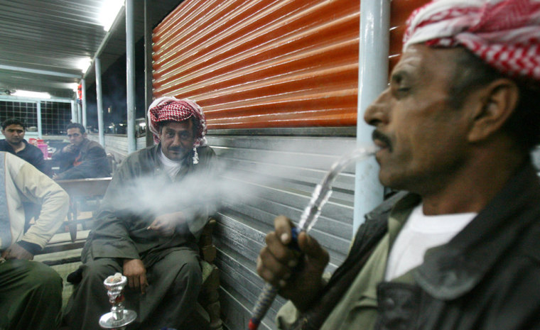 Image: Iraqi men smoke water pipes in the Kazimiyah neighborhood in Baghdad