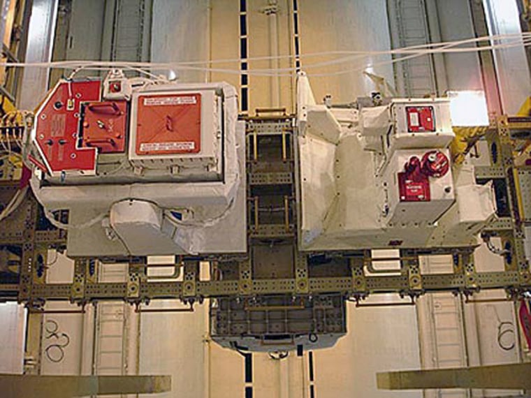 The Columbus external facilities, Solar (left) and EuTEF (right), are prepared to be placed into the Shuttle's payload canister at NASA's Kennedy Space Center, Florida. Atlantis was targeted for launch to the International Space Station on Dec. 6, 2007, but faulty sensors delayed its launch to no earlier than Jan. 2, 2008.