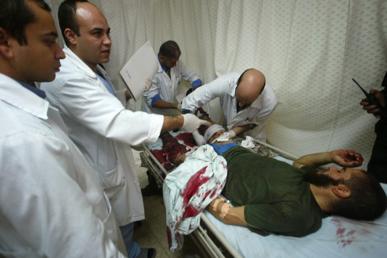 Palestinian doctors treat a wounded man at the European hospital in Rafah, southern Gaza Strip, 11 December 2007. Three Palestinian militants were killed in the Gaza Strip today as Israel carried out the largest operation in months in the south of the Hamas-run territory.