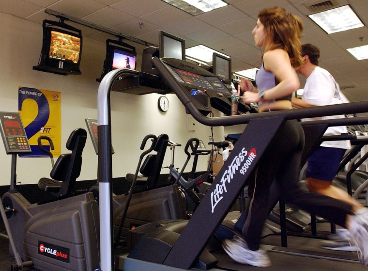 Image:  People run on treadmills at a New York Sports Club January 2, 2003 in Brooklyn, New York.