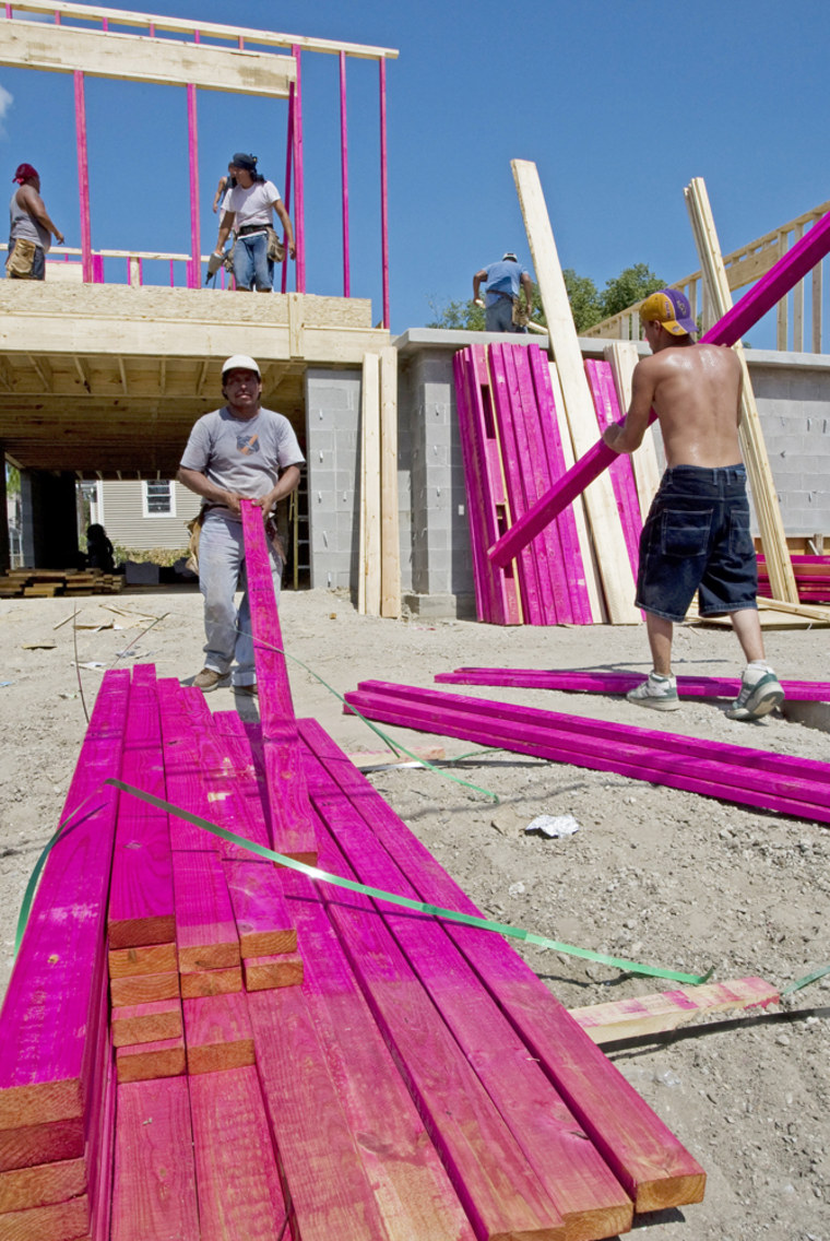 Image: Construction workers build a new home in New Orleans 22 August 2007.