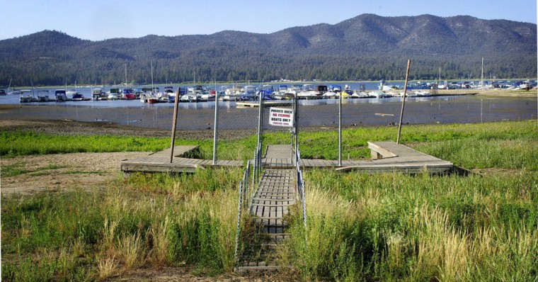 ** ADVANCE FOR SUNDAY DEC. 30--FILE ** A private boat dock is high and dry, showing the low water levels on Big Bear Lake following the driest Southern California winter in more than 100 yearsin this Aug. 13, 2002, file photo, at Big Bear Lake, Calif. As the global climate warms, California's one-of-kind geography and the lifestyle it has made famous will not escape the consequences. (AP Photo/Reed Saxon, File)