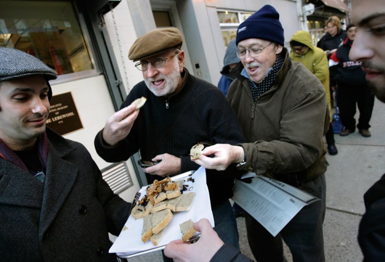 Image:  Chopped liver is served to patrons waiting outside in line for the re-opening of the 2nd Avenue Deli in New York