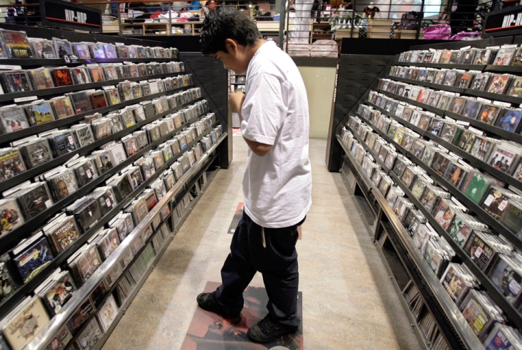 Image: Gaston Chabolla, 15, searches for CDs at a music store in Los Angeles