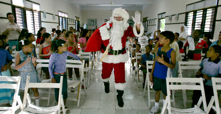 Image: U.S. cattle farmer John Parke Wright, dressed as Santa Claus, arrives at a church during the \"Three Kings Day\" in a convent in Havana