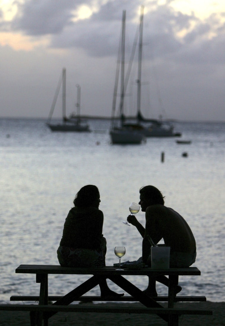 Image:  couple drinks white wine at the end of the day on a beach near Charlotte Amalie, St. Thomas, U.S. Virgin Islands