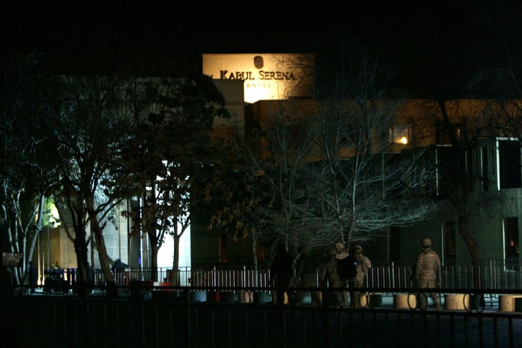 Image: US soldiers walk toward the Serena Hotel after a suicide attack in the city of Kabul.