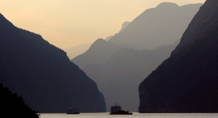 Image: A boat sails at sunset through an area on the Yangtze River known as the Three Gorges in Heibei Province near the town of Badong in the south-west part of China