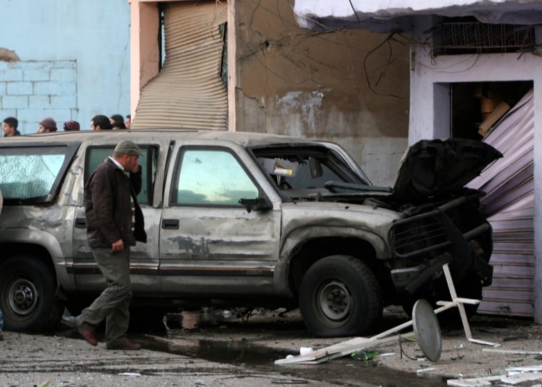 Image: An official inspects a U.S embassy vehicle after an explosion in a suburb north of Beirut.