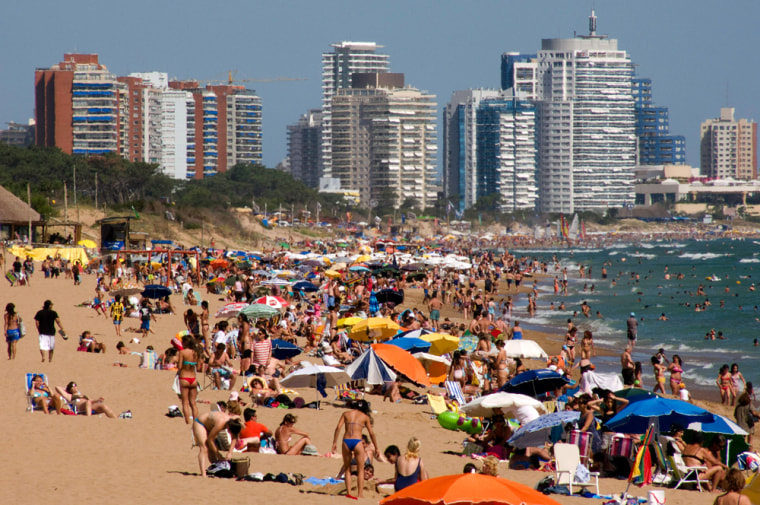 Image: Tourists enjoy summer in a beach of Punta del Este, one of the most exclusive seaside resorts of Latin America.
