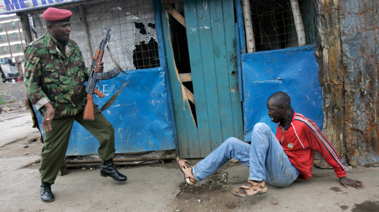 Image: Police officer beats an opposition supporter during riots in Kenya.
