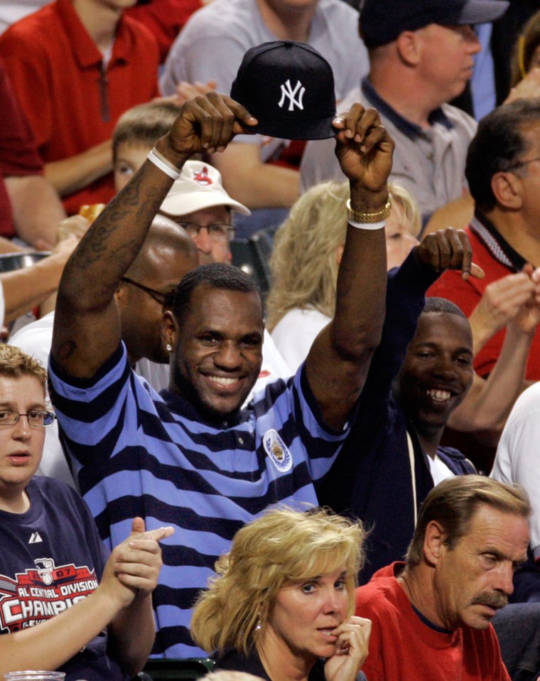 Image: LeBron James holds up his New York Yankees hat
