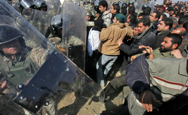 Image: Egyptian border guards and riot police officers clash with Palestinians.