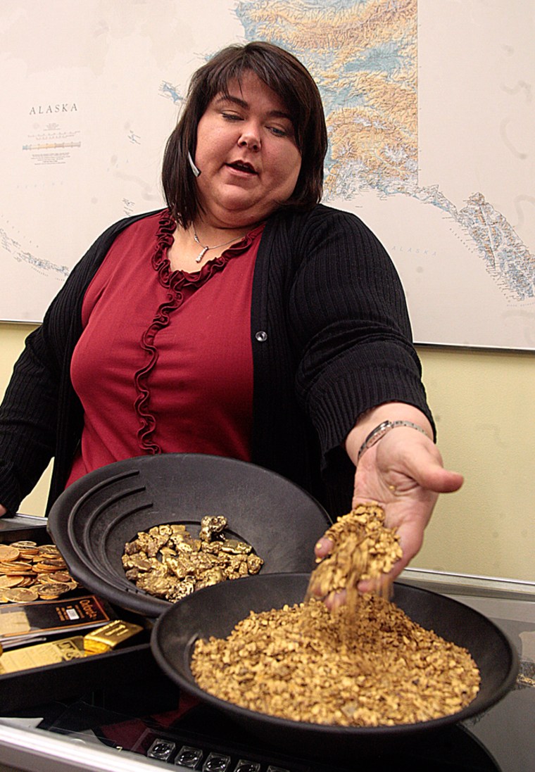Toni Logan Goodrich, co-owner Oxford Assaying and Refining Corp. in Anchorage, Alaska displays gold flakes, next to nuggets and finished gold products at the shop as she talks, Tuesday, Jan. 15, 2008, about how small-scale miners generate 95 percent of the business. The number of small-scale miners is increasing as gold prices spike to an the all-time high of more than $900 an ounce for gold. (AP Photo/ Al Grillo)