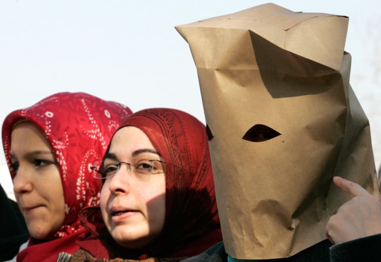 Image: Women wearing paper bags and headscarves