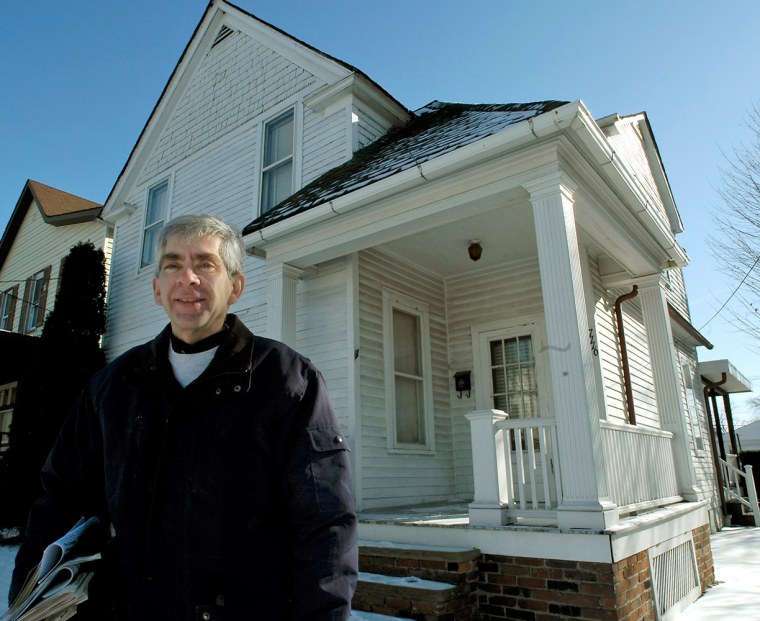 Image: Charles Gliha stands in front of the home he grew up in