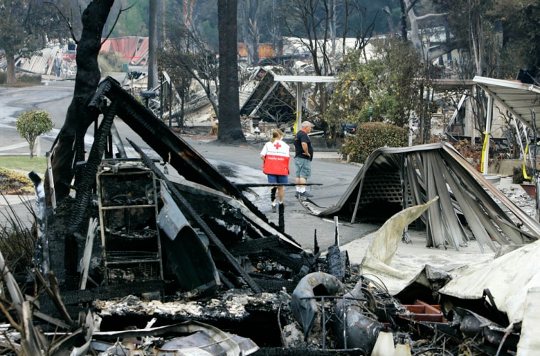 Image: Red Cross workers survey the damage caused by the wildfire Fallbrook, Calif. in Oct. 2007.