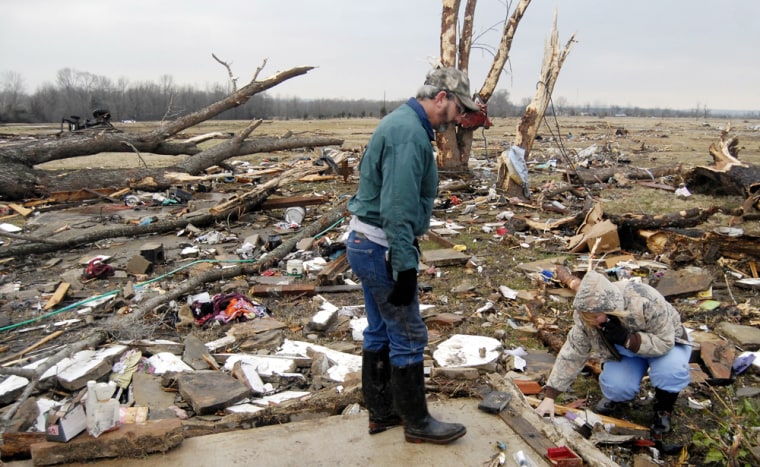 Image: Clay and Seavia Dixon pick through the debris of what is left of their tornado damaged home.