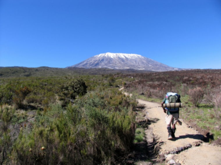 Image: Porter climbing toward Kibo, Mount Kilimanjaro's peak